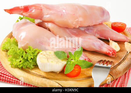 Fresh rabbit meat with raw vegetables on cutting board Stock Photo