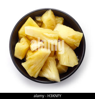 Bowl of canned pineapple chunks isolated on white background, top view Stock Photo