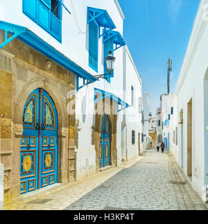 The modest arabic houses often boast unique colorful doors in Tunis. Stock Photo