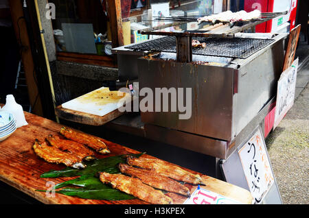 Janpanese people cooking Unagi (eel) or kabayaki or Grilled eels at restaurant on steert for sale traveler between go to Fushimi Stock Photo