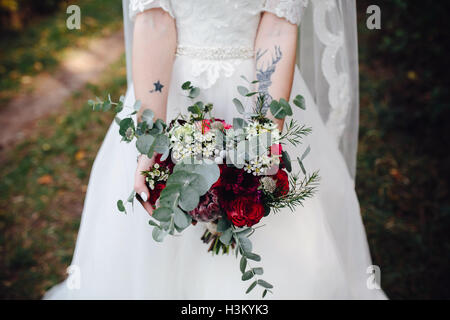 Bride holding wedding bouquet Stock Photo