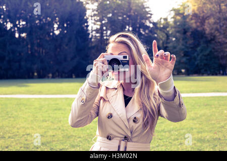 Attention, female is taking picture with old foto camera Stock Photo