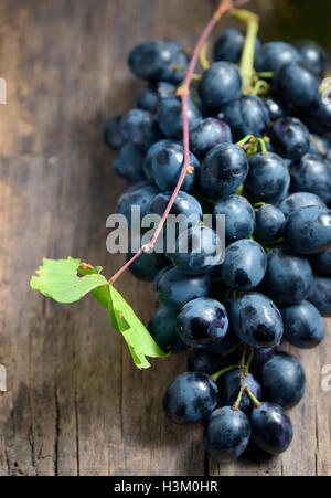 Bunch of red grapes on wooden table background Stock Photo