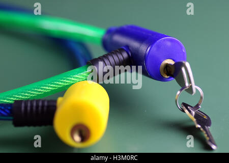bicycle lock with key on green table isolated Stock Photo