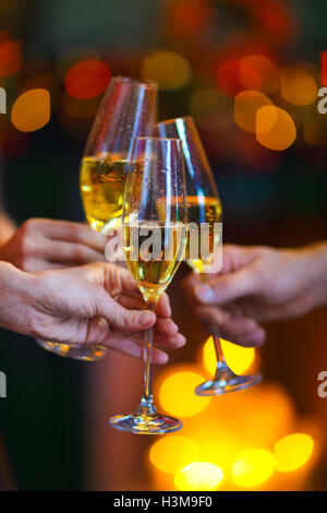 Holiday illuminations and champagne glass. Christmas party. Toast Stock Photo