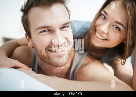 Smiling young couple looking at camera Stock Photo