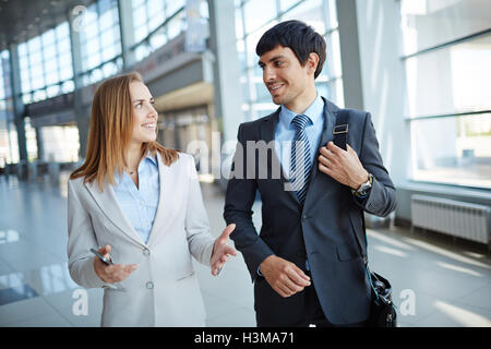 Two colleagues having business discussion on the move Stock Photo