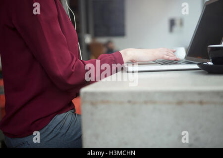 Businesswoman working with laptop in cafe Stock Photo