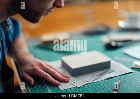 Young man working in print studio, close-up Stock Photo