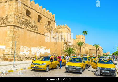 The large taxi stand next to the Bab El Kasbah Gates, the drivers clean their cars and wait for the clients in Sfax. Stock Photo