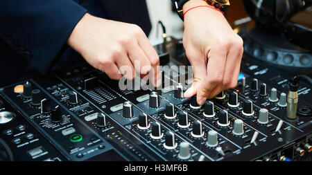 Dj mixes the track in the nightclub at party Stock Photo