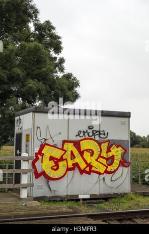 Garish graffito on wall of trackside railway building Milton Cambridge Cambridgeshire England 2016 Stock Photo