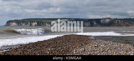 View from the beach at Seaton, where the River Axe runs into the sea, looking across Seaton Bay to the white cliffs of Beer Head Stock Photo