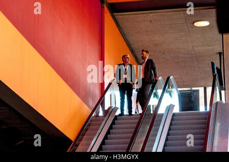 Business conference attendees on an esculator at the conference centre in St.Gallen, Switzerland Stock Photo