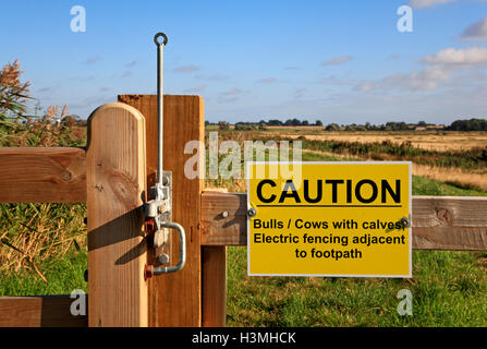 Caution sign on public footpath gateway by the River Bure at Clippesby, Norfolk, England, United Kingdom. Stock Photo