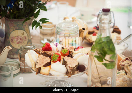 A selection of pretty cakes set out on a table Stock Photo