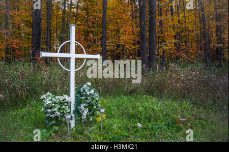Unknown person grave marker in a deciduous forest. Stock Photo