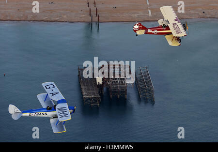 An English Tiger Moth DH82A (left) and a Canadian Travel Air 4000 fly over Brighton in East Sussex during a photo call for vintage bi-planes before the announcement of an 8,000+ mile Vintage Air Rally. The aviation adventure, across Africa with 10 international teams, will recreate the pioneering days of flight from the 1920s testing the pilots skills and aircraft, while raising funds for charity. Stock Photo