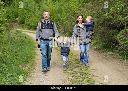 young family going for walk in the woods Stock Photo