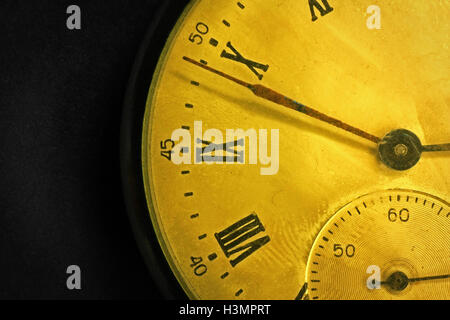 Tarnished clock face of old soviet pocket watch close up on dark background Stock Photo