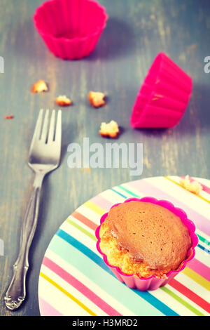 Vintage toned homemade muffin cup cake on a plate, shallow depth of field. Stock Photo
