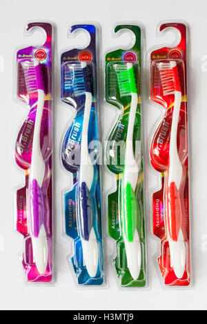 Four different coloured Dr Brush medium toothbrushes set on white background Stock Photo