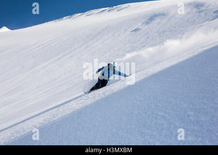 Male snowboarder snowboarding down steep mountain, Trient, Swiss Alps, Switzerland Stock Photo