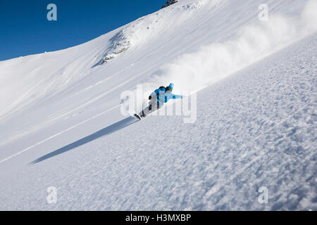 Male snowboarder speeding down steep mountain, Trient, Swiss Alps, Switzerland Stock Photo