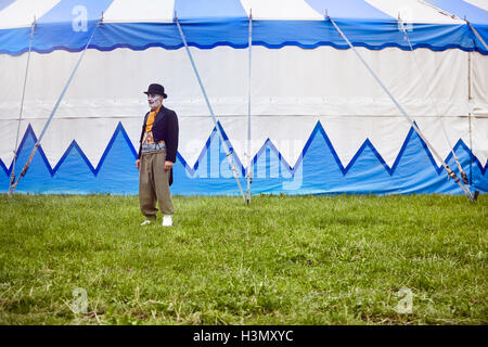 Portrait of senior male circus clown outside circus tent Stock Photo