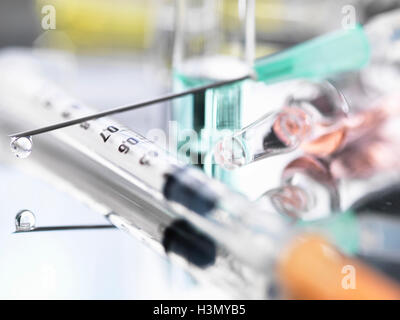 Ampoule and medical drug-filled syringe Stock Photo