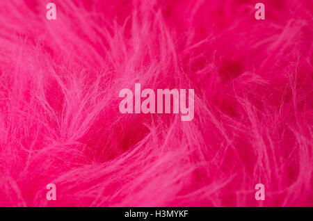 Pink plush fabric horizontal. Very soft polyester textile made of synthetic fibers with long hairs. Macro close up photo. Stock Photo