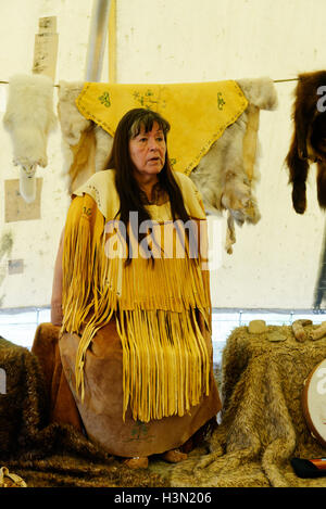 A native american (Micmac) woman speaking in a wigwam, with traditional ...