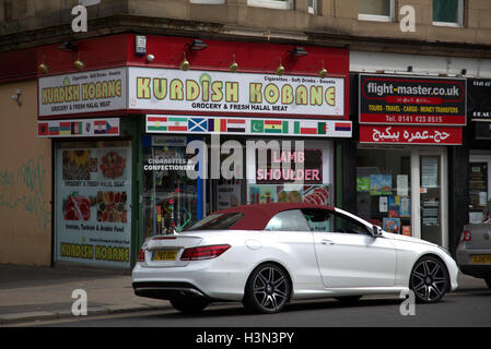 Kurdish business in Britain UK with Turkish origins emphasizing Kurd roots, grocery shop and barber shop or hairdressers Stock Photo