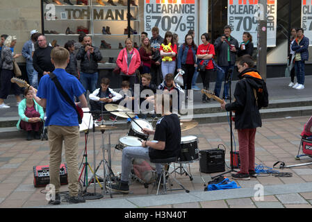 Street musicians  young teenage boys busking on Sauchihall Street, Glasgow Stock Photo