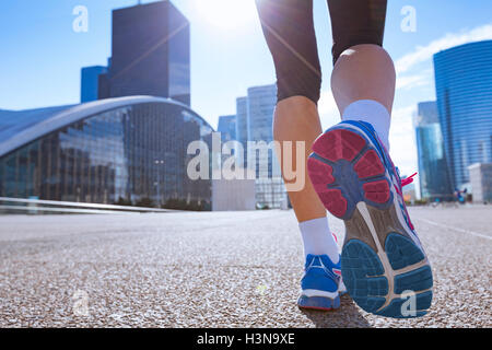 Woman running in the city Stock Photo