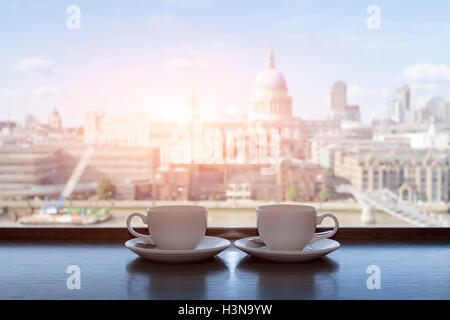 Two cups of coffee with panoramic view of a city in background Stock Photo