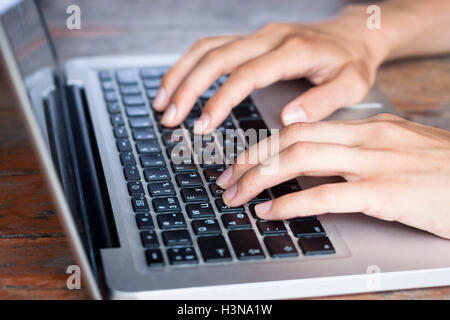 Soft young female hands typing on a modern computer keyboard Stock Photo