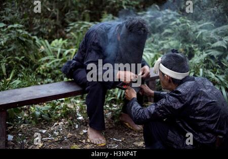 China. 10th Oct, 2016. Guizhou, CHINA-October 10 2016:?(EDITORIAL USE?ONLY.?CHINA OUT) People of Miao ethnic minority group perform a traditional worship ceremony in Datang Village, Congjiang County, southwest ChinaÂ¡Â¯s Guizhou Province, October 10th, 2016, praying for harvest and prosperity of the next year. Miao people usually hold worship ceremonies in the second, third, eighth and ninth months of Chinese traditional lunar calendar. Preserved meat, chicken, rice and a jar of Miao liquor are placed on a long table during the worship ceremony, and people standing around it chanting. (Cred Stock Photo