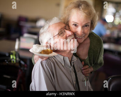 Senior woman hugging senior man, smiling Stock Photo