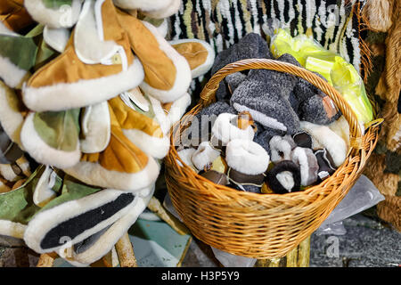 Warm handmade slippers presented in the basket at one of the stands during the Christmas market in Riga, Latvia. Selective focus Stock Photo