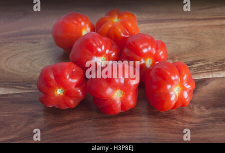 red ripe tomatoes on a wooden table Stock Photo