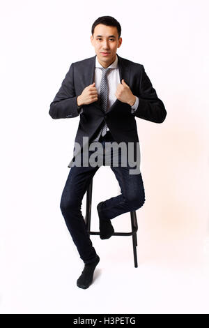 young Kazakh business man in glasses with phone on white background Stock Photo