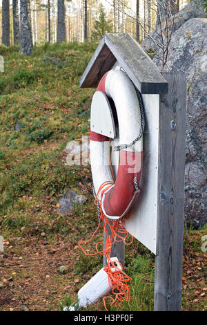 Old life buoy hanging on the beach. Stock Photo