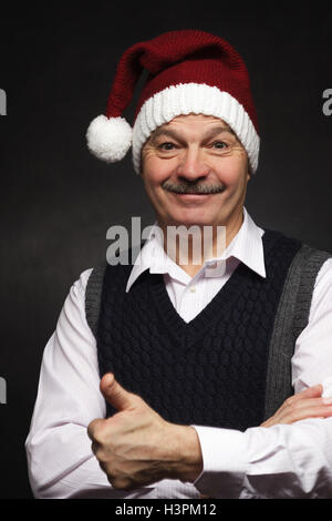Happy man in a New Year's cap laughing. Preparing for the New Year and Christmas Stock Photo