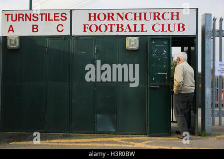 A spectator arrives at the ground and enters through the main turnstile block - AFC Hornchurch vs Wingate & Finchley - Ryman League Premier Division Football at Hornchurch Stadium, Bridge Avenue, Upminster, Essex - 30/11/13 Stock Photo