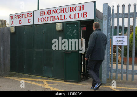 A spectator arrives at the ground and enters through the main turnstile block - AFC Hornchurch vs Wingate & Finchley - Ryman League Premier Division Football at Hornchurch Stadium, Bridge Avenue, Upminster, Essex - 30/11/13 Stock Photo