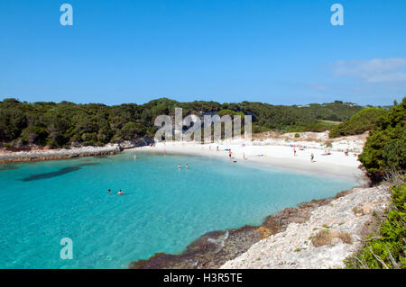 Some tourist relaxing on beautiful Petit Sperone beach, Corsica island, France Stock Photo