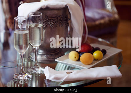 Still life, romantic dinner, two glasses and champagne in the ice bucket. Celebration or holiday Stock Photo