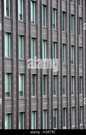 Exterior wall with many windows of multi-storey building. Stock Photo