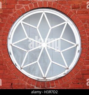Old round window with brick wall background Stock Photo